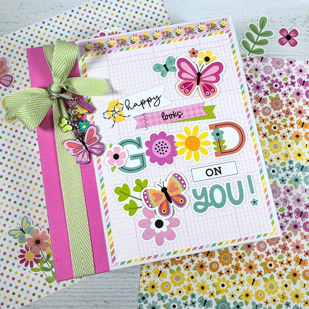 Butterfly Kisses Spring Scrapbook Mini Album with flowers, a bow, and a pretty charm