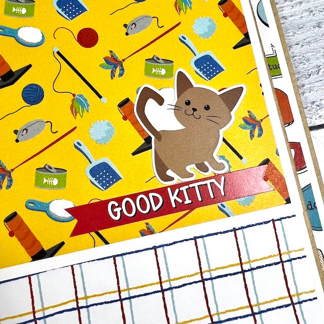 Cat scrapbook album page with cat toys & food dish
