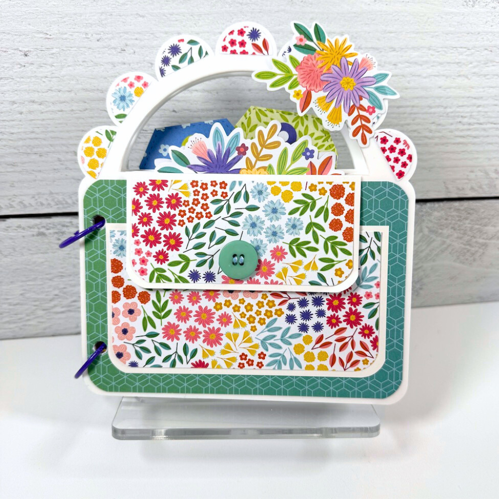 Blooming Wild Purse Shaped Acrylic Scrapbook Mini Album on a clear acrylic display stand
