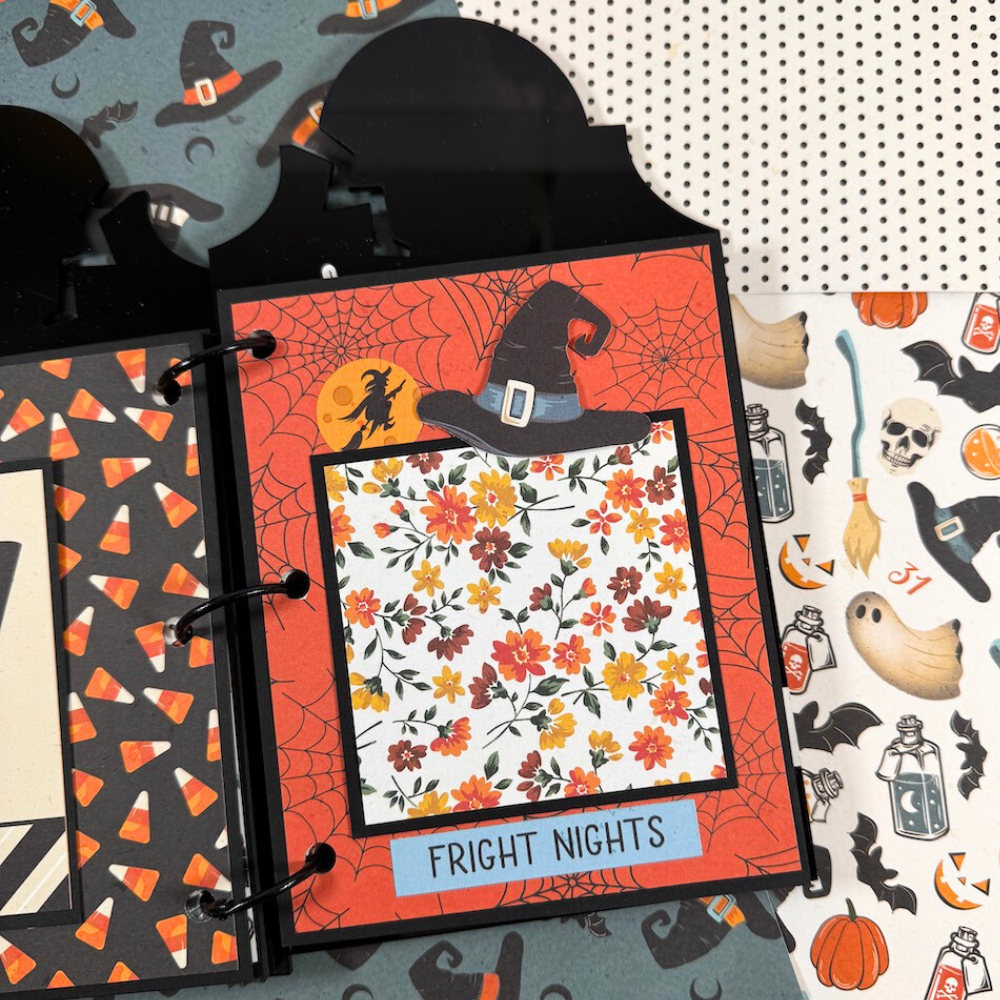 Halloween Tombstone Shaped Scrapbook Album Page with a witch, spider webs, flowers, a hat, and candy corn