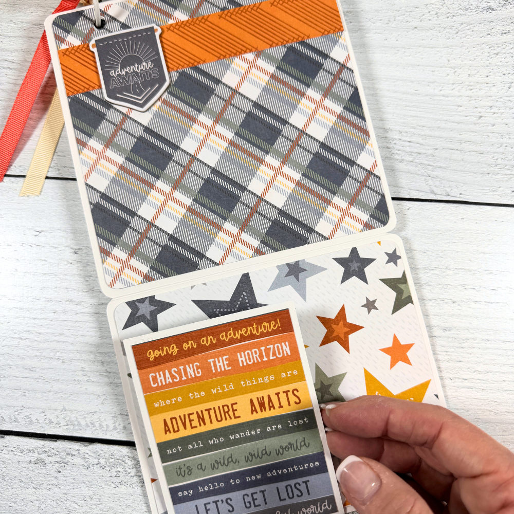 Adventure Scrapbook Mini Album Page with a plaid paper, colorful stars, and a folding card with outdoor sayings