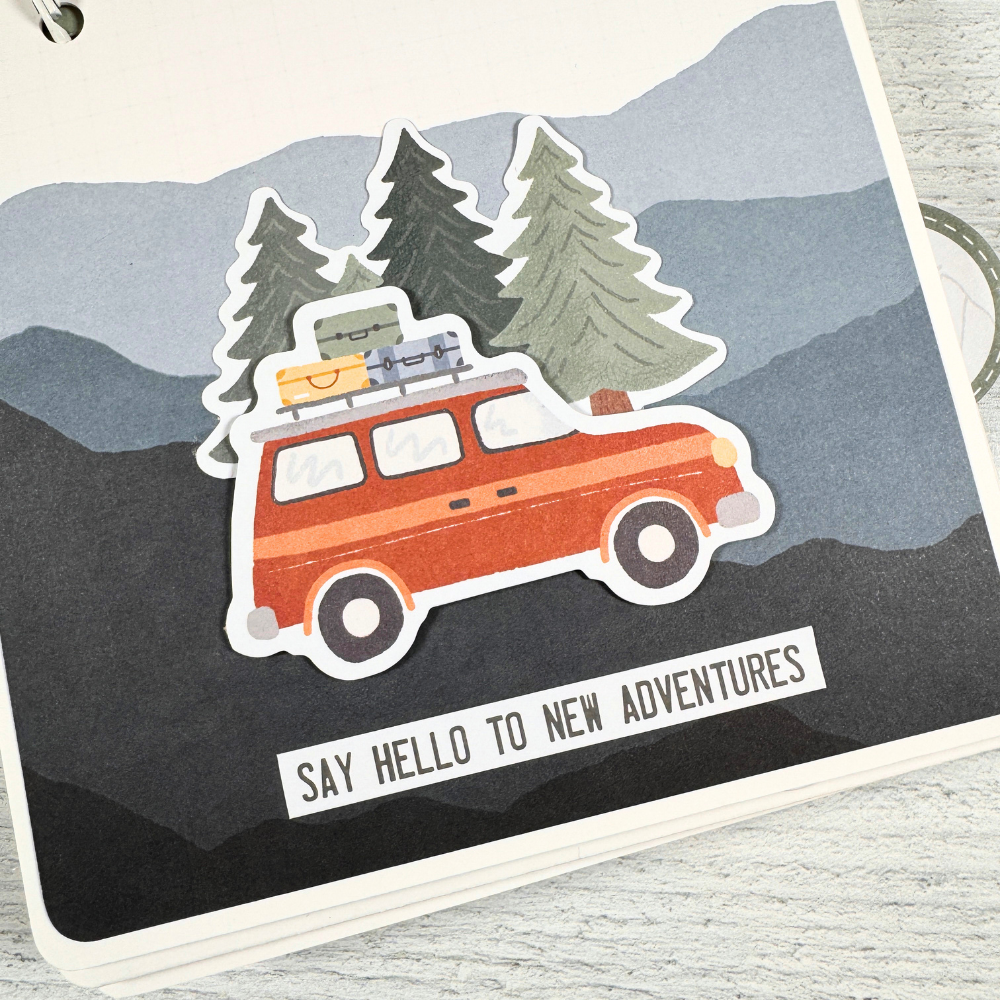 Adventure Scrapbook Mini Album Page with mountains, trees, and a car with luggage