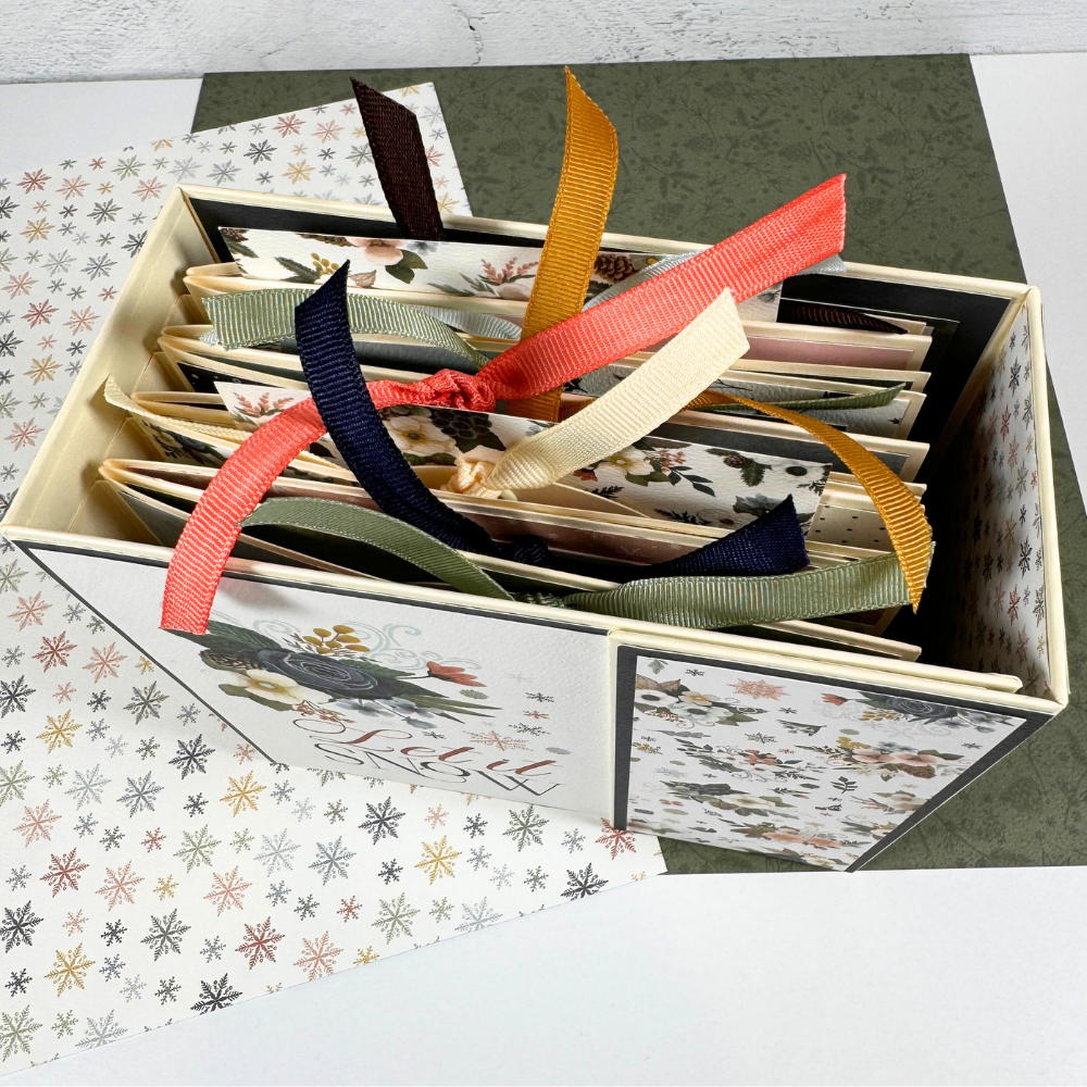 Let It Snow Scrapbook Album with layered pages, tags, and ribbons