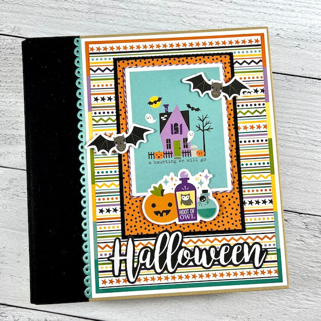 Halloween scrapbook album with haunted house, bats, pumpkins and potion bottles