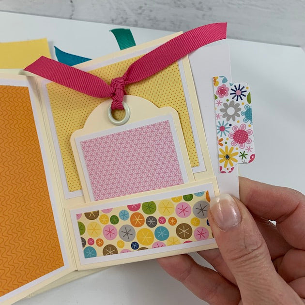 Hello Friend Scrapbook Mini Album page with a pocket, a tag, and ribbon