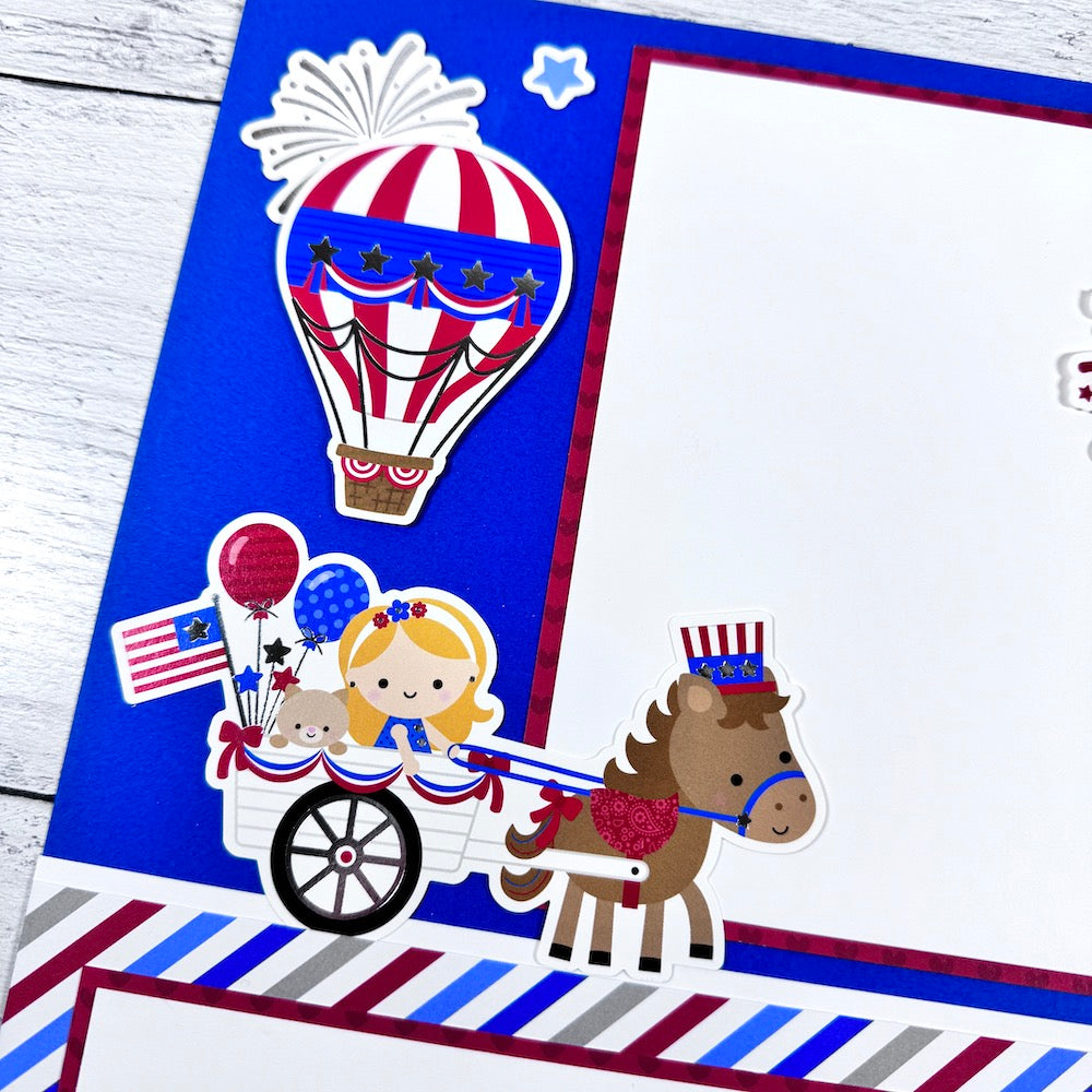 July 4th 12x12 Scrapbook Page Layout with a hot air balloon, fireworks, a flag, and a horse pulling a cart