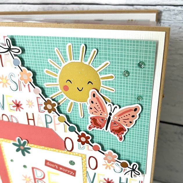 Be Happy Scrapbook Album with sunshine, flowers, butterflies, rainbows, and glitter dots