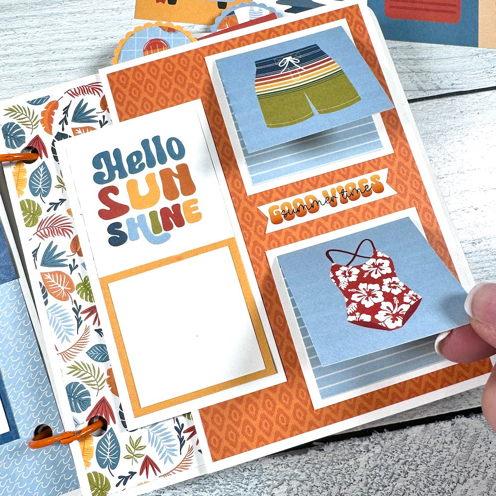 Chasing the Sun Summer Scrapbook Album Page with swim suits, tropical leaves, and folding cards for more photos
