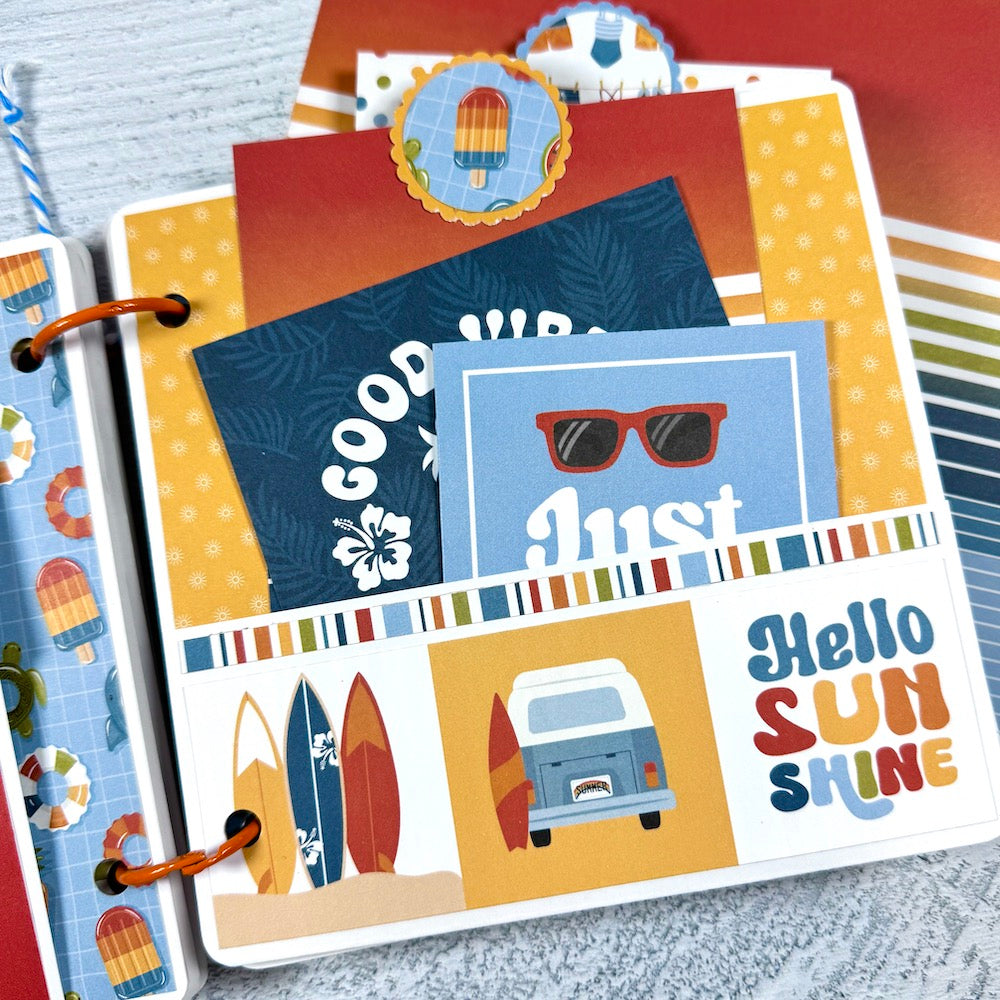 Chasing the Sun Summer Scrapbook Album Page with surfboards, a volkwagen bus, a pocket, and journaling cards