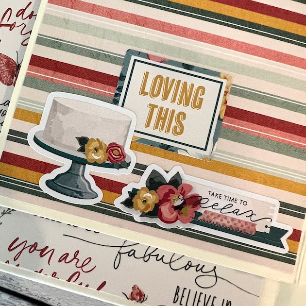 Handmade scrapbook page with a cake, flowers, and stripes
