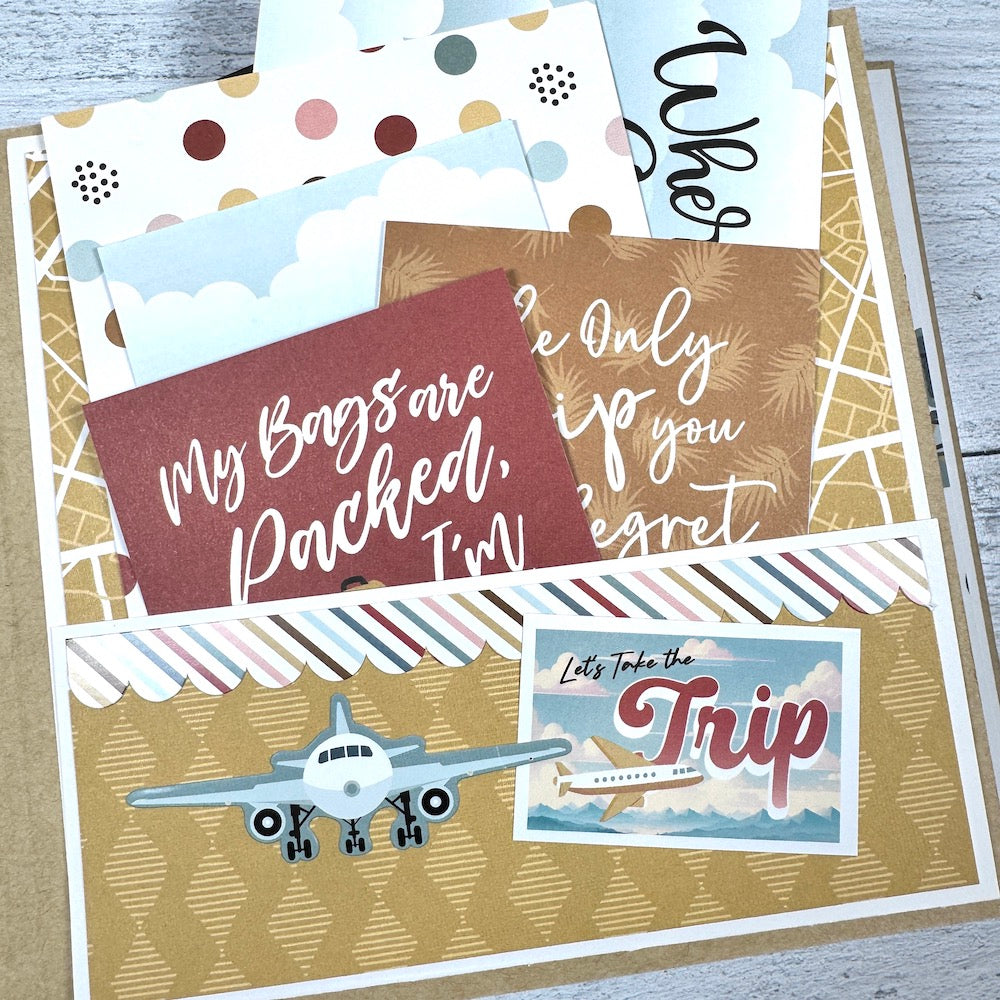 Travel The World With Me Scrapbook Album page with an airplane, a pocket, and journaling cards