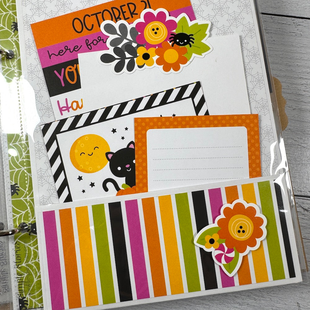 Halloween Scrapbook Album Page with a colorful rainbow pocket and fun journaling cards