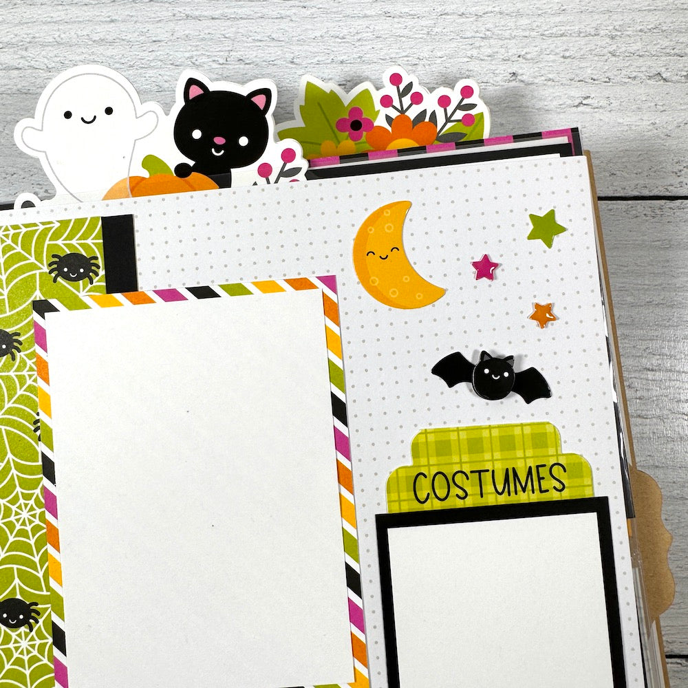 Halloween Scrapbook Album Page with a ghost, a cute black cat, a bat, moon, and stars