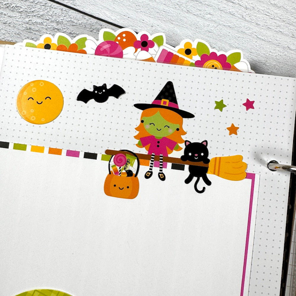 Halloween Scrapbook Album Page with a cute witch on a broom, a bat, moon, and stars