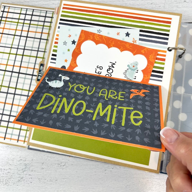 Be Fierce Dinosaur Scrapbook Album page with dinosaurs, a pocket, and journaling cards