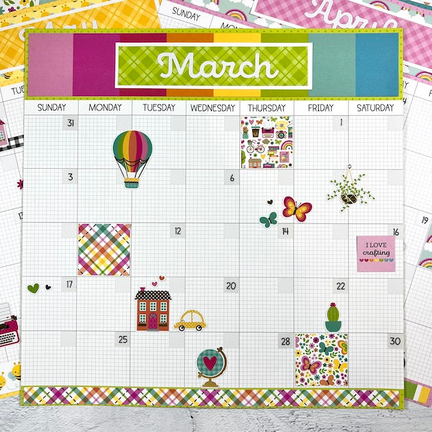 12x12 Monthly Calendar Scrapbook Layout with a hot air balloon, butterflies, and lots of other cute stickers