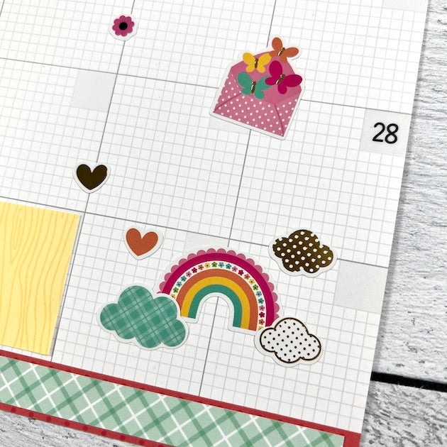 12x12 Monthly Calendar Scrapbook Layout with a rainbow and cute clouds