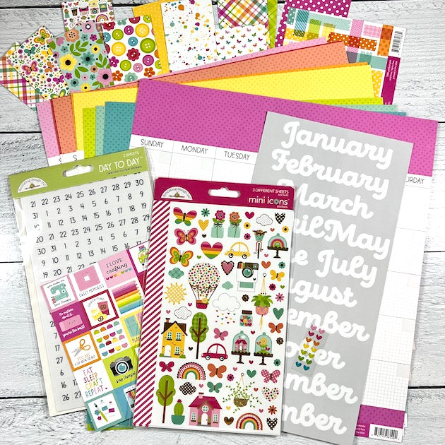12x12 Monthly Calendar Scrapbook Layouts with colorful paper, embellishments, and stickers