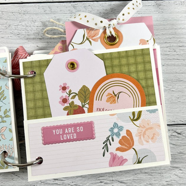Friend & Family Scrapbook pocket page with flowers, journaling cards, and tags with ribbon
