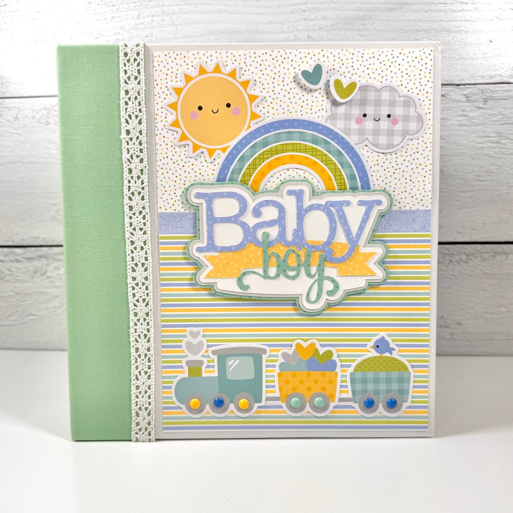 My Baby Boy Scrapbook Album with a cute train, stripes, a rainbow, sun, and clouds