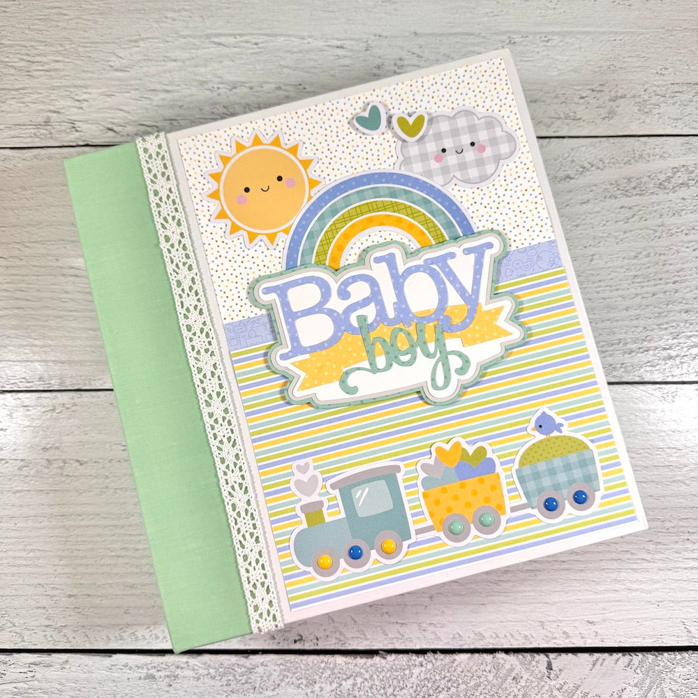 My Baby Boy Scrapbook Album with a cute train, stripes, a rainbow, sun, and clouds