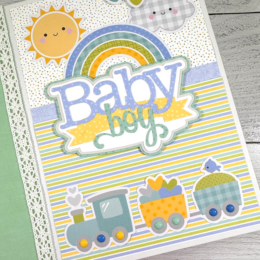 My Baby Boy Scrapbook Album with a cute train, stripes, a rainbow, sun, and clouds