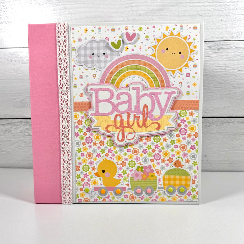 My Baby Girl Scrapbook Album with pretty flowers, a rainbow, a cute duck, a train, sun, and clouds