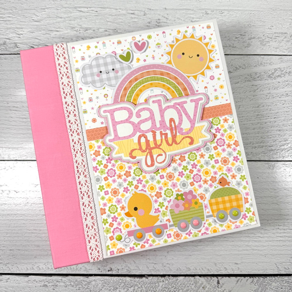 My Baby Girl Scrapbook Album with pretty flowers, a rainbow, a cute duck, a train, sun, and clouds