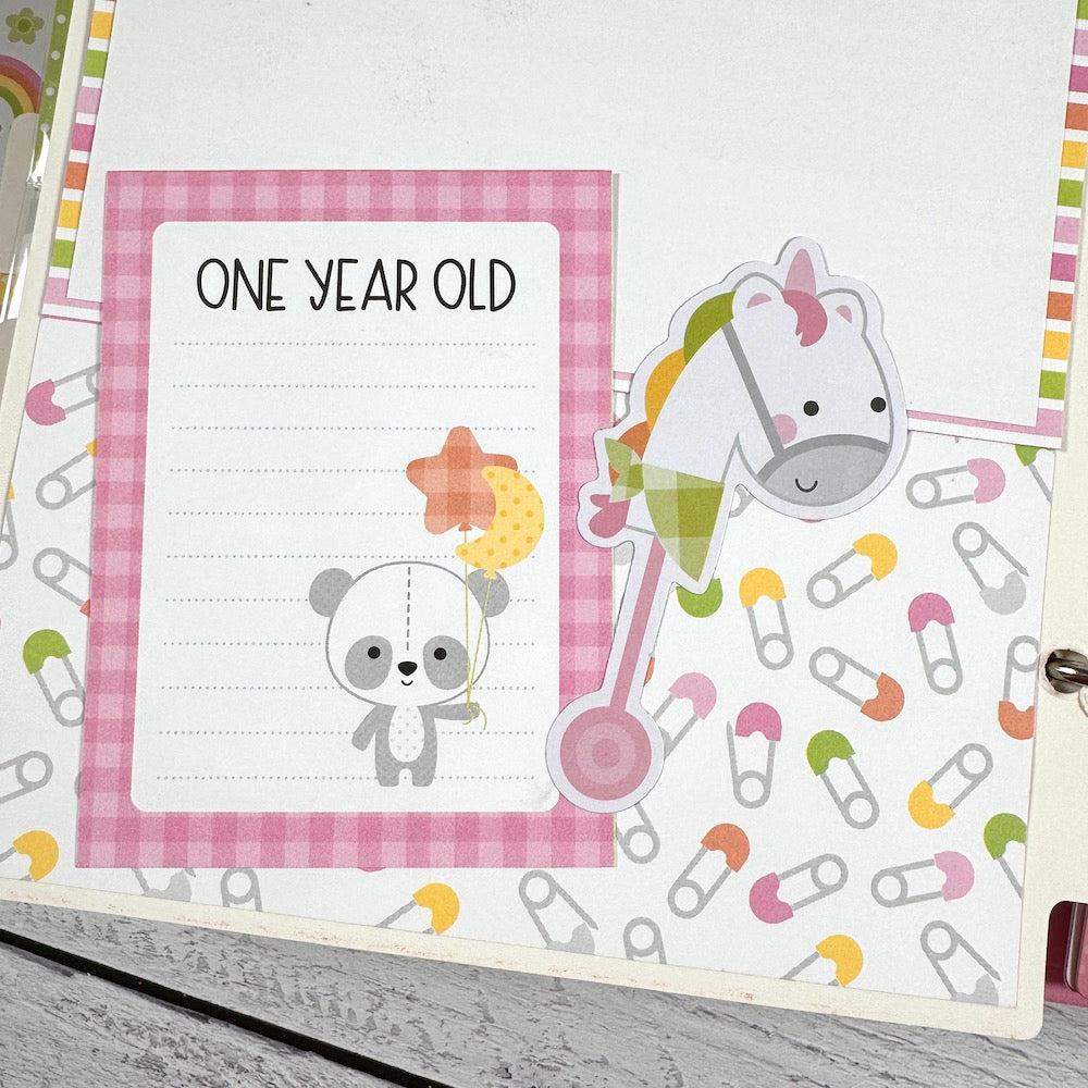 My Baby Girl Scrapbook Album page with a journaling card, a panda bear, balloons, a toy horse, and safety pins