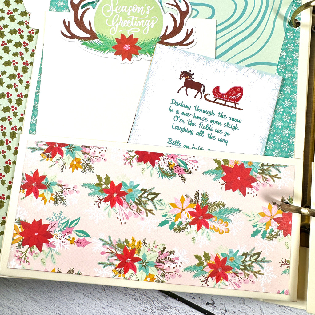 Holly Jolly Days Christmas Scrapbook Album page with a pocket, journaling cards, a horse and sleigh, and colorful poinsettia flowers