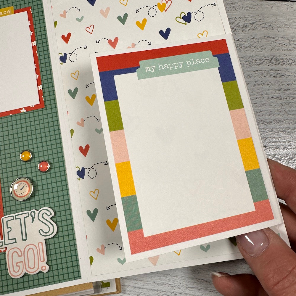 Road Trip Travel Scrapbook Album page with a folding card, colorful hearts, stripes, and enamel brads