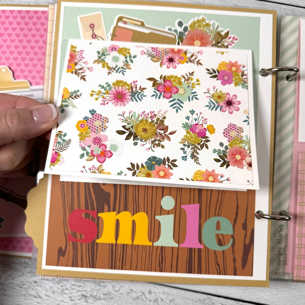 Everyday Life Scrapbook Album Page with flowers, a pocket, and a folding card that says smile!