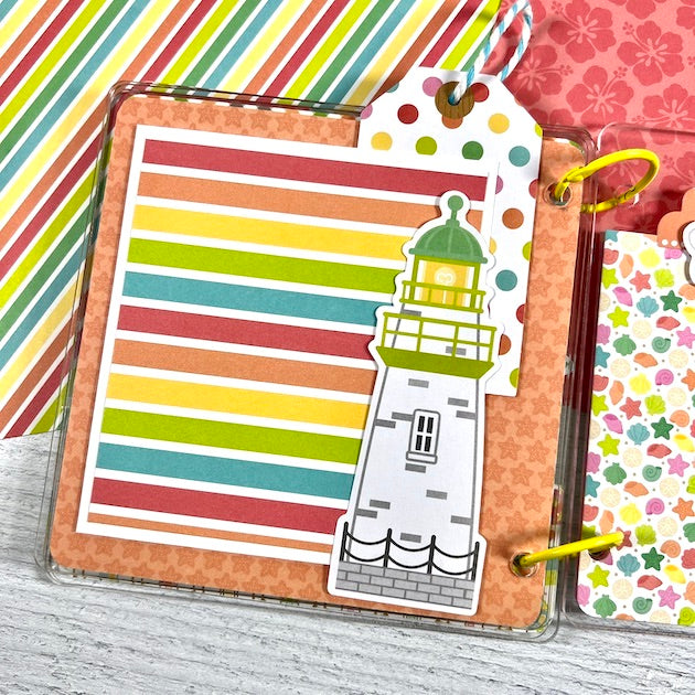 Seaside Summer Scrapbook Album page with a lighthouse, seashells, & tropical flowers
