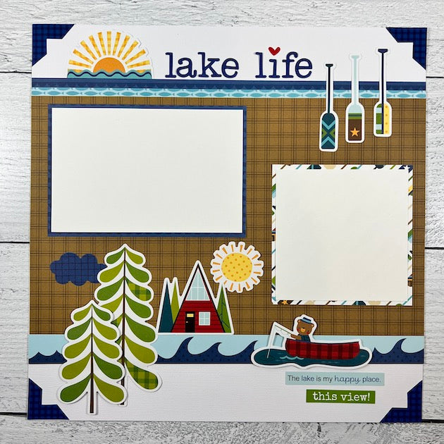 12x12 Lake Life Scrapbook Page with trees, sunshine, a canoe, a fishing bear, and cabin