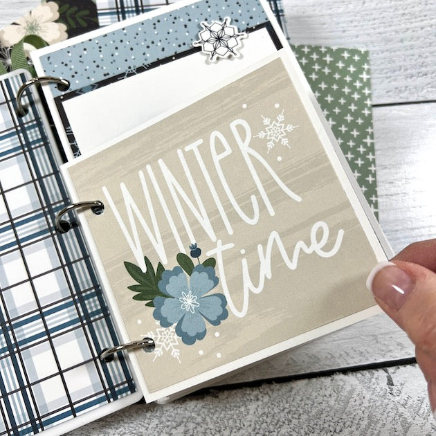 Winter Scrapbook Album Page with snowflakes, flowers, a plaid print, and polka dots