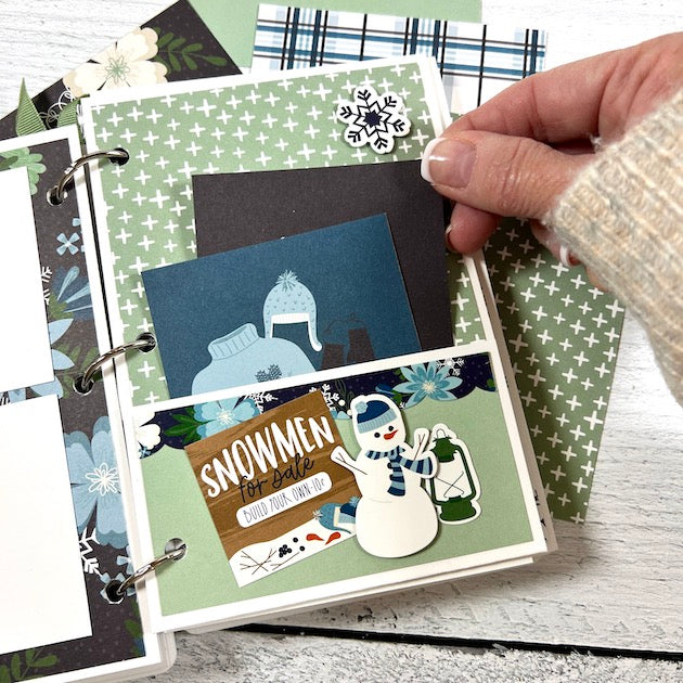 Winter Scrapbook Album Page with a snowman, a pocket, and lots of cute journaling cards