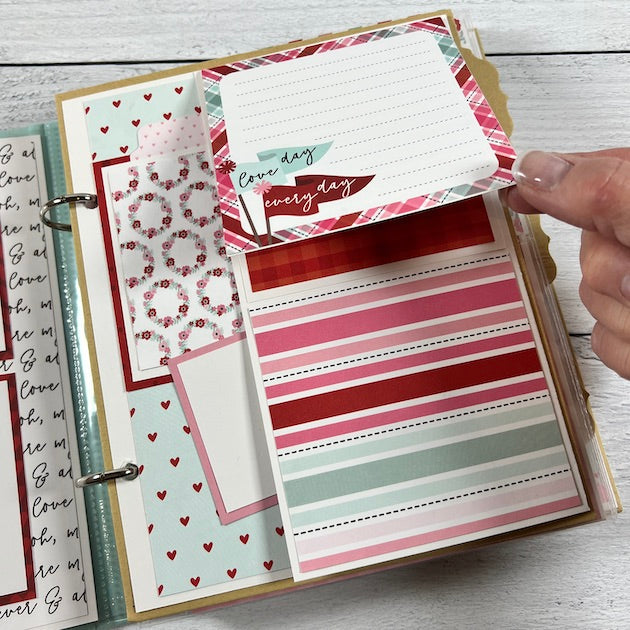 Love Valentine scrapbook album page with hearts, flowers, stripes, and a journaling card
