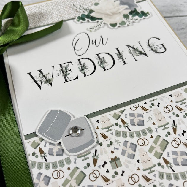 Our Wedding Scrapbook Album with a ring box and a sparkly rhinestone on the cover