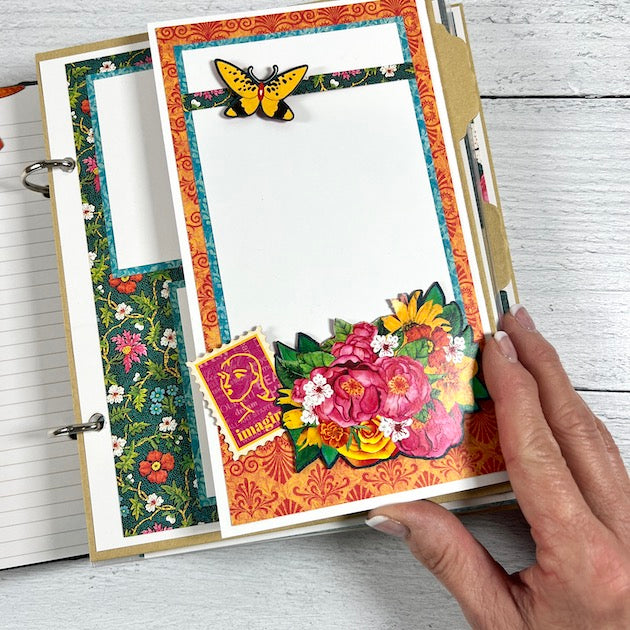 Let's Get Artsy Scrapbook Album Page with bright colors, a butterfly, a folding element, and beautiful flowers