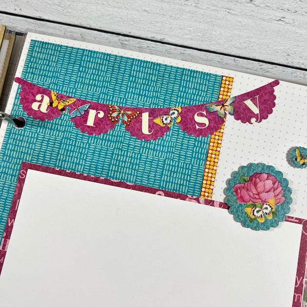 Let's Get Artsy scrapbook album page with vibrant colors, a banner, and flowers