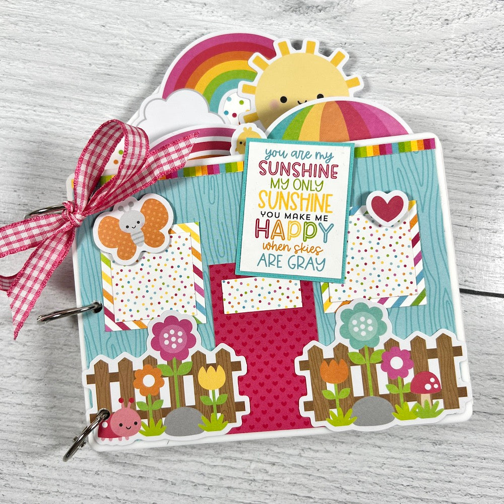 Spring Scrapbook Mini Album with flowers, rainbows, ladybugs, and butterflies
