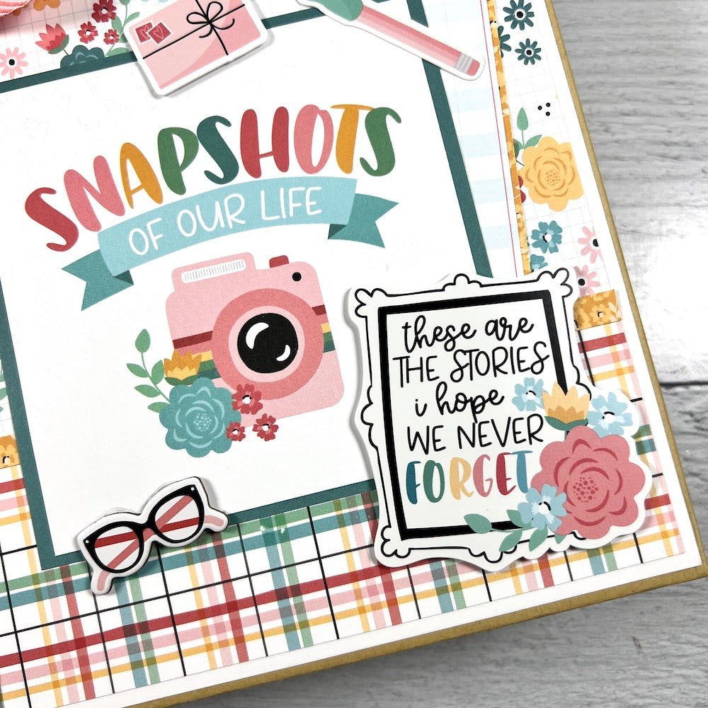 Snapshots of Our Life Scrapbook Album with pretty flowers, plaid paper, a pink camera, and glasses