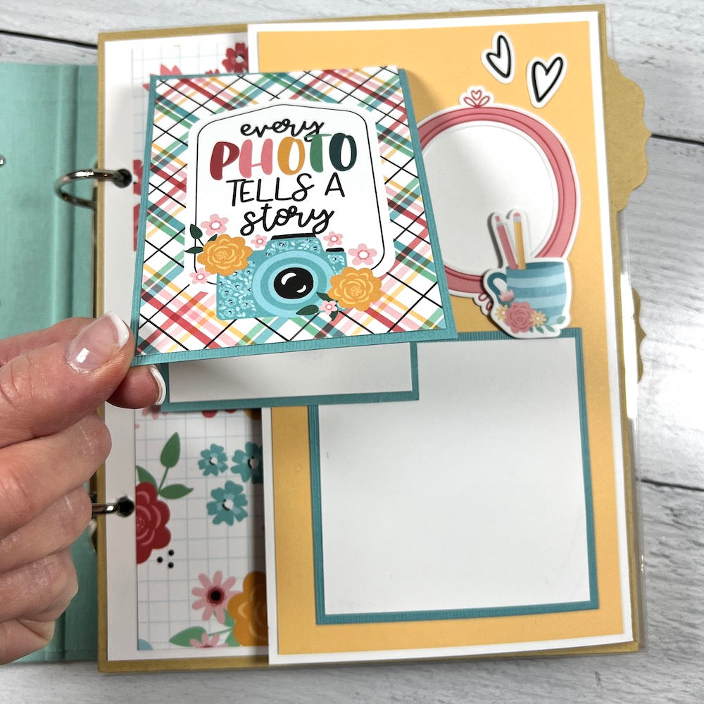 Our Life scrapbook album page with pretty flowers, plaid paper, and a camera