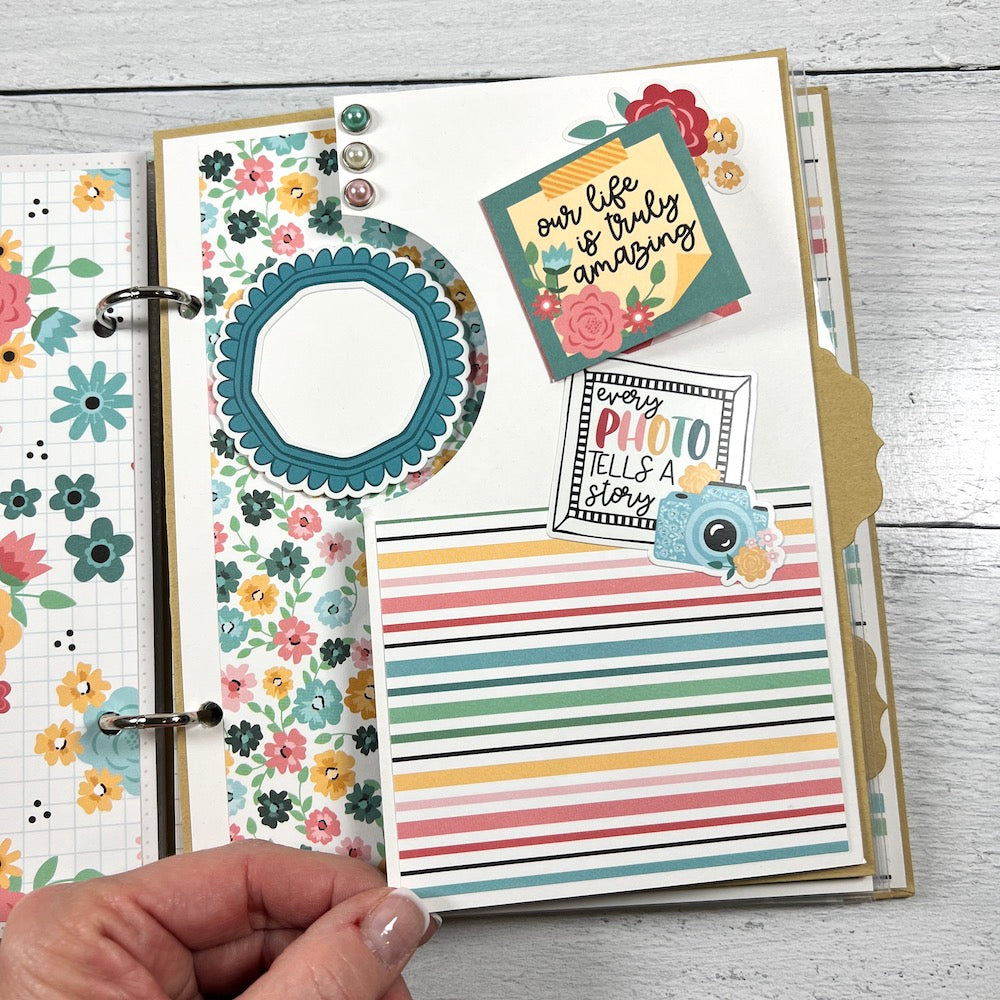 Our Life scrapbook album page with pretty flowers, stripes, and a folding element