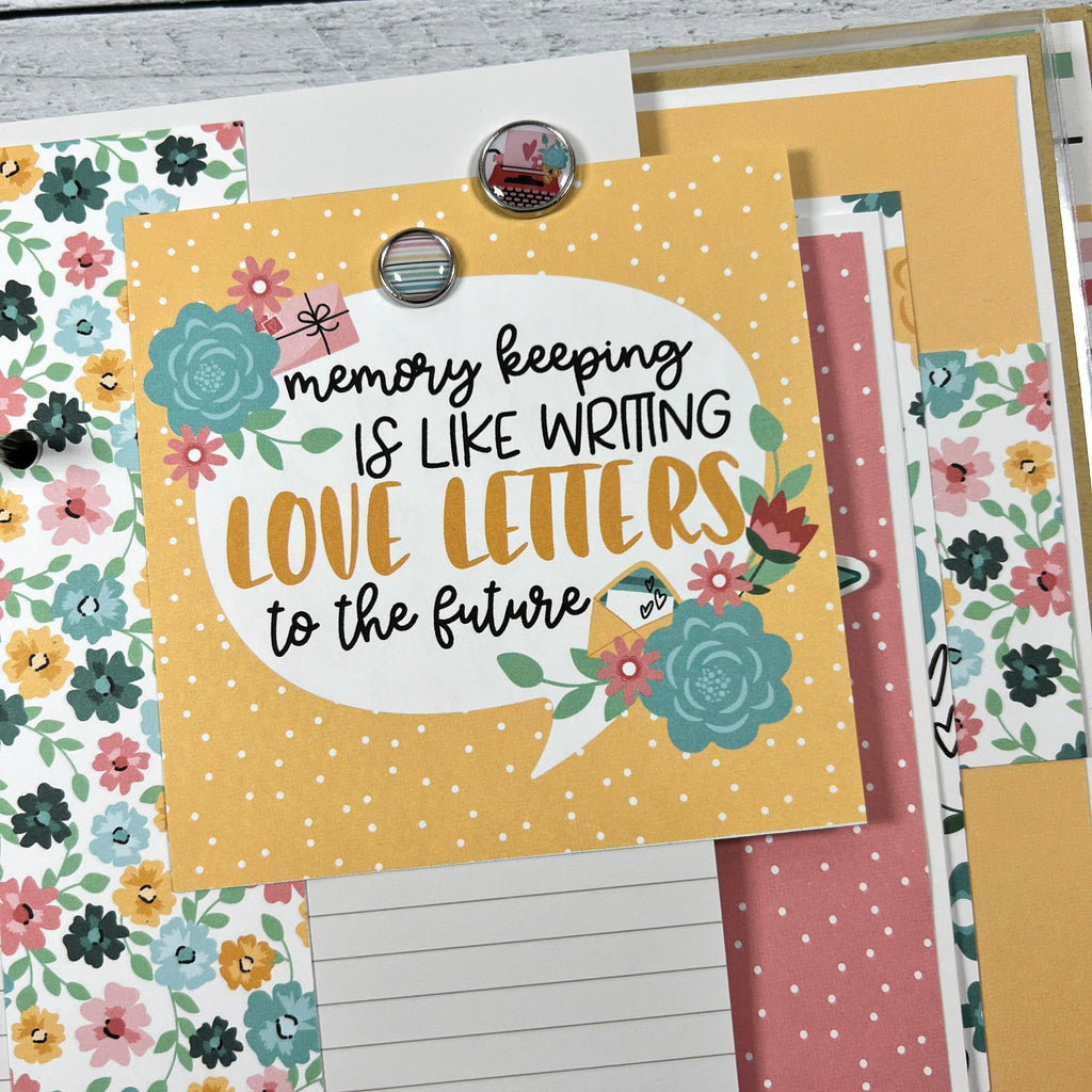 Our Life scrapbook album page with pretty flowers, a journaling card, and enamel brads