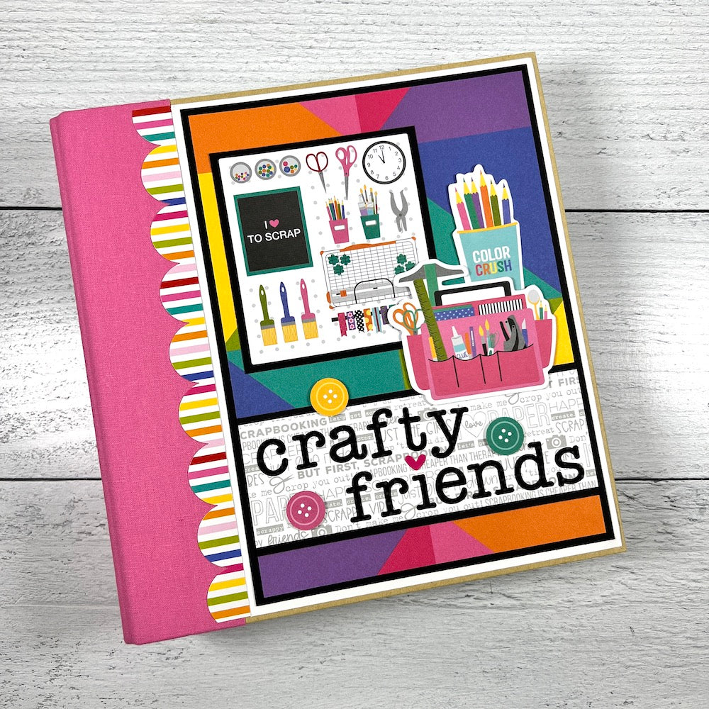 Crafty Friends scrapbook album with a scalloped rainbow border, a pink binder album, and lots of crafting supplies