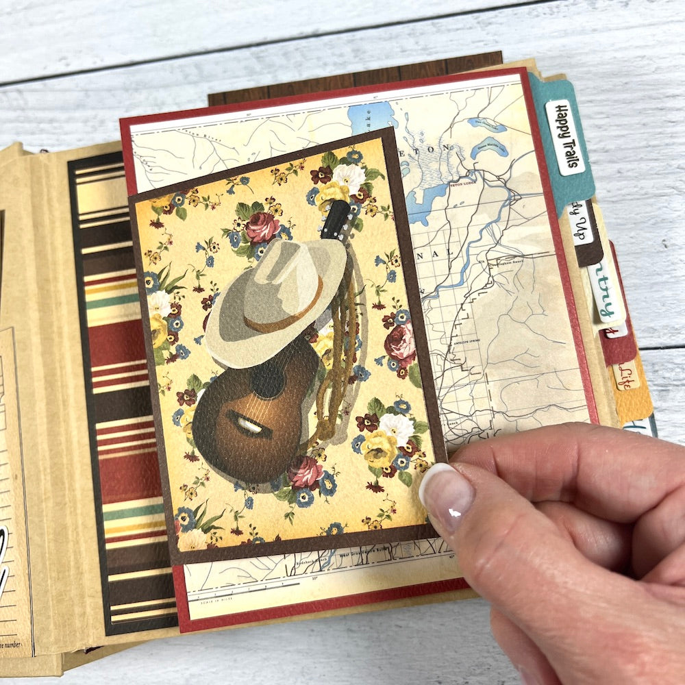 Country Western Scrapbook Mini Album Page with flowers, a map, a cowboy hat, and a guitar