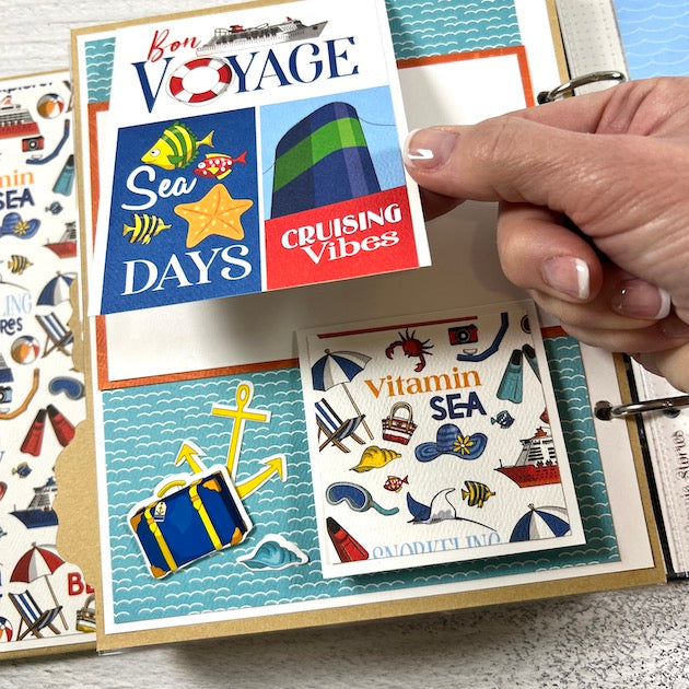 Bon Voyage Cruise Scrapbook album page with beach supplies, fish, luggage, & an anchor