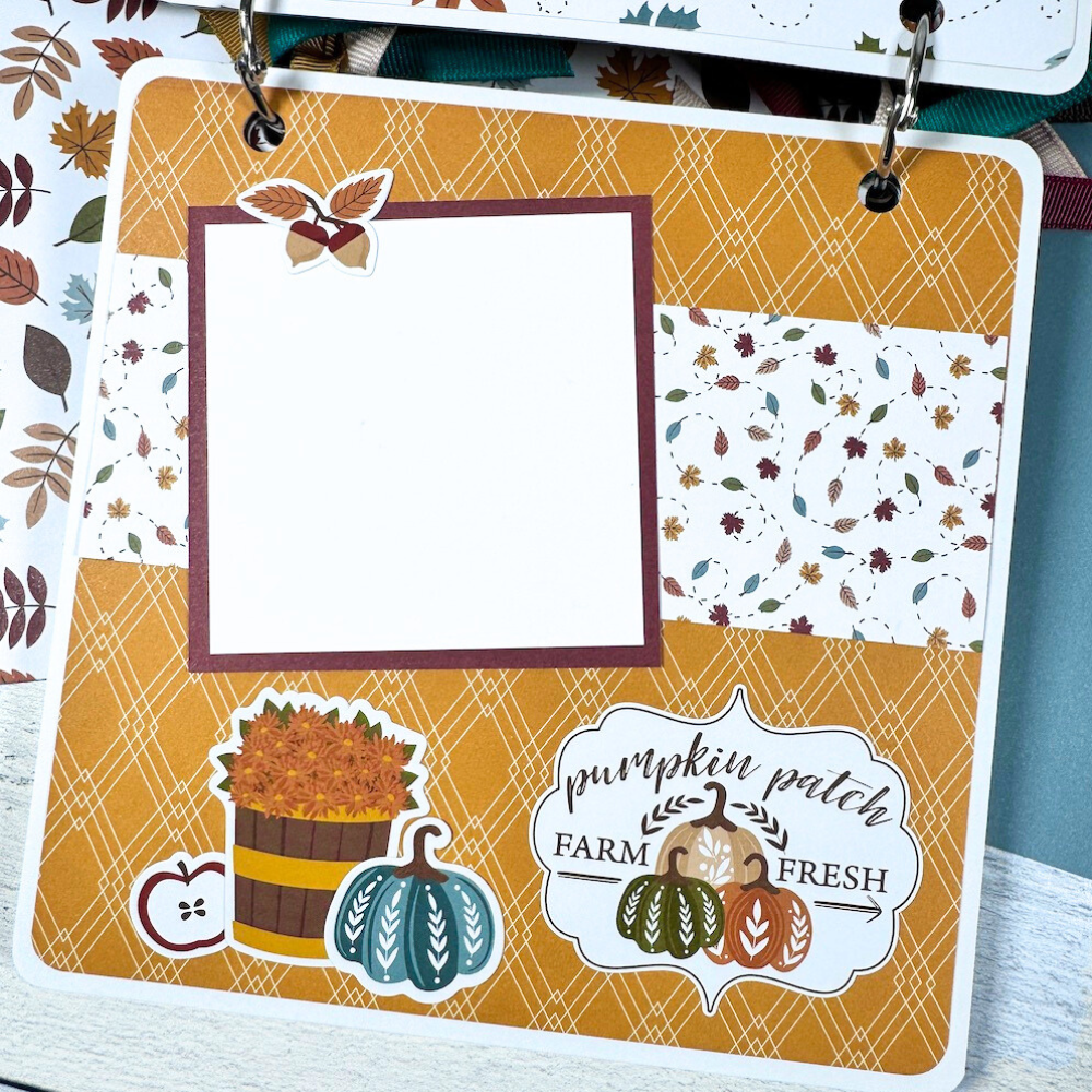 Sweater Weather Fall Scrapbook Album page with a basket of flowers, leaves, and pumpkins
