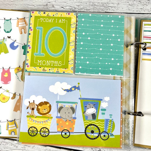 Baby Boy Scrapbook Album Page with a monthly card, a train, and cute little animals